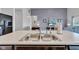 Kitchen island featuring stainless steel sink and ample counter space, ideal for food preparation at 8044 Yarmouth Way, Indianapolis, IN 46239