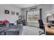 Functional home office with a comfortable sofa, desk, and natural light from the window at 8044 Yarmouth Way, Indianapolis, IN 46239