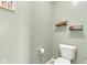 Charming powder room with decor shelves, complemented by a toilet and neutral wall paint at 8044 Yarmouth Way, Indianapolis, IN 46239