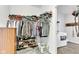 Functional walk-in closet with shelves for shoes and clothes, next to laundry machines at 8044 Yarmouth Way, Indianapolis, IN 46239
