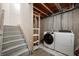 Basement with washer and dryer hookups located by a staircase and exposed framework at 8199 Sydney Ln, Avon, IN 46123