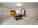 Unfinished basement area with a billiard table and doorway revealing additional space at 8199 Sydney Ln, Avon, IN 46123