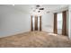 Bright bedroom featuring neutral carpet, a ceiling fan, and large windows with curtains for natural light at 8199 Sydney Ln, Avon, IN 46123