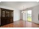 Bright dining area with glass doors, natural light, and a large china cabinet at 8199 Sydney Ln, Avon, IN 46123
