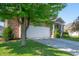 Charming brick home featuring an attached two-car garage and well-maintained landscaping at 8199 Sydney Ln, Avon, IN 46123