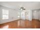 Bright living room featuring wood floors, ceiling fan, and large windows at 8199 Sydney Ln, Avon, IN 46123
