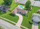 Aerial view of brick ranch home with in-ground pool, pergola, and well-manicured lawn at 8209 Burn Ct, Indianapolis, IN 46217