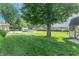 An expansive backyard includes a storage shed, a playground nearby, and a pristine blue in-ground pool at 8209 Burn Ct, Indianapolis, IN 46217