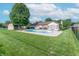 In-ground pool with diving board surrounded by patio, pergola, shed, and lawn at 8209 Burn Ct, Indianapolis, IN 46217