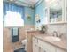 Decorated bathroom with vanity, shower, tub, and beach-themed decorations at 8209 Burn Ct, Indianapolis, IN 46217