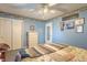Bedroom featuring blue walls, a ceiling fan, carpet, closet, and a dresser at 8209 Burn Ct, Indianapolis, IN 46217