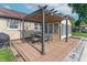 A covered deck features an outdoor dining table, a brick wall, and an extension to the house with many windows at 8209 Burn Ct, Indianapolis, IN 46217