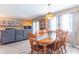 Bright dining area features a wood table and chairs near a brick fireplace and sliding glass doors at 8209 Burn Ct, Indianapolis, IN 46217