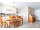 Traditional dining room with wood table, chairs, and desk, plus decorative car art and plank flooring at 8209 Burn Ct, Indianapolis, IN 46217
