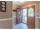 An open foyer features two elaborate paneled doors, light tan walls, and off-white trim at 8209 Burn Ct, Indianapolis, IN 46217