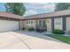 Brick ranch home exterior featuring a curved driveway, attached garage, flower boxes and covered entry at 8209 Burn Ct, Indianapolis, IN 46217