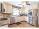 This well-lit kitchen is equipped with stainless steel appliances, tile countertops, and a ceiling fan at 8209 Burn Ct, Indianapolis, IN 46217