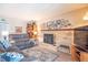Comfortable living room with brick fireplace, plush gray sofa, and a flat-screen TV at 8209 Burn Ct, Indianapolis, IN 46217