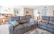 Relaxing living room with plush gray reclining sofa, decorative pillows, and adjacent kitchen at 8209 Burn Ct, Indianapolis, IN 46217