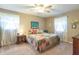 Comfortable main bedroom with a ceiling fan, carpet floors, and coordinated furnishings at 8209 Burn Ct, Indianapolis, IN 46217