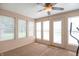 Bright sunroom with ample natural light, neutral carpet, and a ceiling fan for added comfort at 8209 Burn Ct, Indianapolis, IN 46217