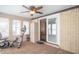 Enclosed sunroom with exercise equipment, brick accent wall, and access to the outdoors at 8209 Burn Ct, Indianapolis, IN 46217