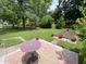 Spacious backyard with large trees, patio, and garden area at 828 N Clarkdale Dr, Muncie, IN 47304