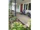 Charming front porch with red front door, blue shutters, and rocking chairs at 828 N Clarkdale Dr, Muncie, IN 47304