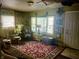 Cozy living room with vintage decor, patterned rug and plentiful seating at 828 N Clarkdale Dr, Muncie, IN 47304