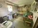 Bright home office space with desk, shelving, and comfortable seating area at 828 N Clarkdale Dr, Muncie, IN 47304