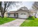 Charming single-story home featuring an attached garage, well-maintained lawn and inviting curb appeal at 829 Meadow Ln, Greenfield, IN 46140