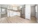 Updated kitchen featuring stainless steel appliances, white cabinetry, and modern backsplash at 829 Meadow Ln, Greenfield, IN 46140