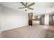 Spacious living room view into updated kitchen featuring modern stainless steel appliances and cabinetry at 829 Meadow Ln, Greenfield, IN 46140