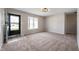 Open-concept living room featuring a bay window, neutral paint, and a tiled entryway at 829 Meadow Ln, Greenfield, IN 46140