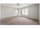 Bright living room featuring a new carpet, neutral walls, and a large front window at 829 Meadow Ln, Greenfield, IN 46140