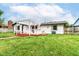 Backyard features a lawn, perimeter fence, and a pergola covered porch at 8445 Montery Rd, Indianapolis, IN 46226