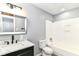 Modern bathroom featuring a white tub and shower combo, along with a stylish black vanity at 8445 Montery Rd, Indianapolis, IN 46226
