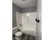 Renovated bathroom with a white tiled shower-tub, modern fixtures, and clean design at 8445 Montery Rd, Indianapolis, IN 46226