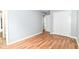 A simple bedroom with hardwood floors, a closet, and light gray paint throughout at 8445 Montery Rd, Indianapolis, IN 46226