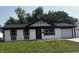 Charming home featuring a painted brick exterior, black trim, a red front door, and a well-manicured lawn at 8445 Montery Rd, Indianapolis, IN 46226