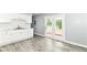 Bright kitchen with white cabinets, stainless steel sink, and doors leading to the backyard at 8445 Montery Rd, Indianapolis, IN 46226