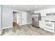 Bright kitchen with stainless steel fridge, white appliances, and durable floors at 8445 Montery Rd, Indianapolis, IN 46226