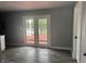 Bright living room with gray walls features french doors with views of backyard at 8445 Montery Rd, Indianapolis, IN 46226