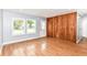 Spacious living room features hardwood floors, wood accent wall, and natural light from double paned windows at 8445 Montery Rd, Indianapolis, IN 46226
