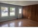 Bright living room with hardwood floors, natural light from two windows, and paneled accent wall at 8445 Montery Rd, Indianapolis, IN 46226
