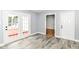 Well-lit living room boasting modern flooring and an exterior door at 8445 Montery Rd, Indianapolis, IN 46226