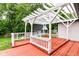 Covered porch with red wood and a pergola cover overlooks the lawn at 8445 Montery Rd, Indianapolis, IN 46226