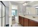 Bright bathroom featuring a double sink vanity, framed mirror, and a shower with glass door at 848 Silverheels Dr, Westfield, IN 46074