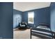 Cozy blue bedroom featuring a chair, twin bed and natural light at 848 Silverheels Dr, Westfield, IN 46074