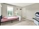 Minimalist bedroom with a single bed, large window overlooking greenery and carpeted floors at 848 Silverheels Dr, Westfield, IN 46074
